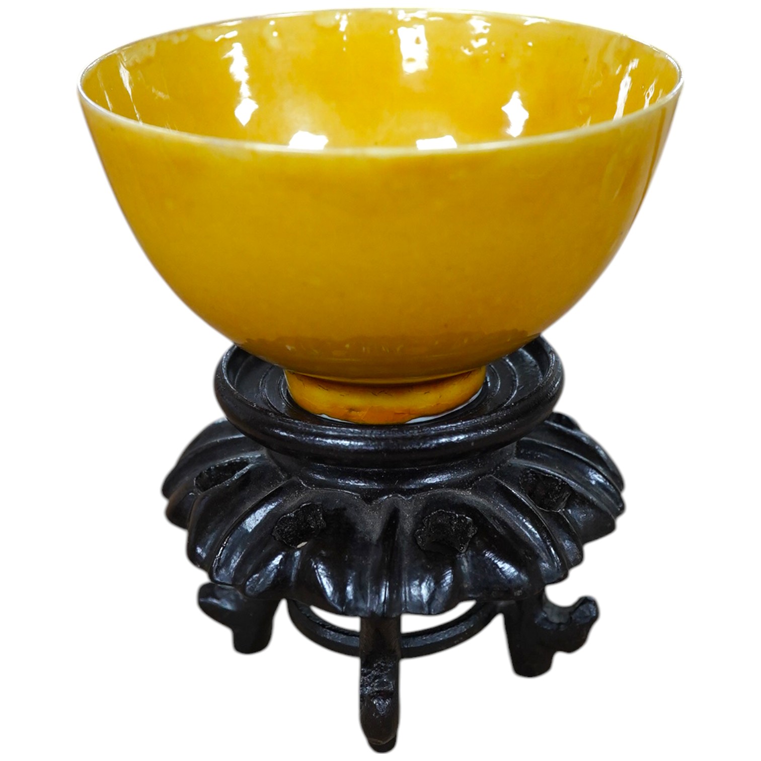 A Chinese yellow glazed teabowl on hardwood stand, 9cm diameter. Condition - fair